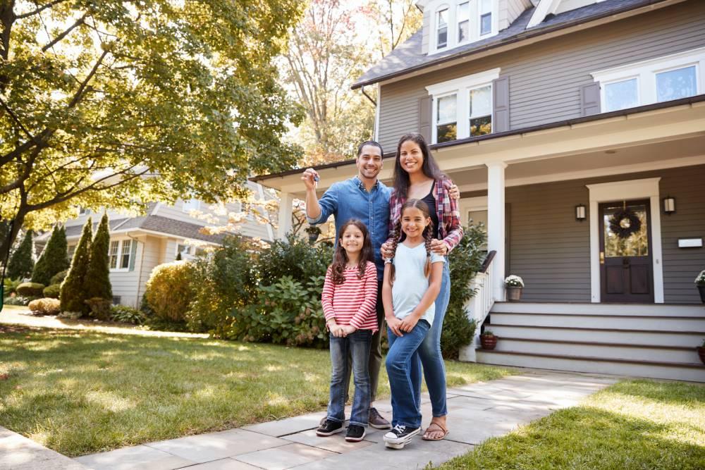 Family holding keys to new home