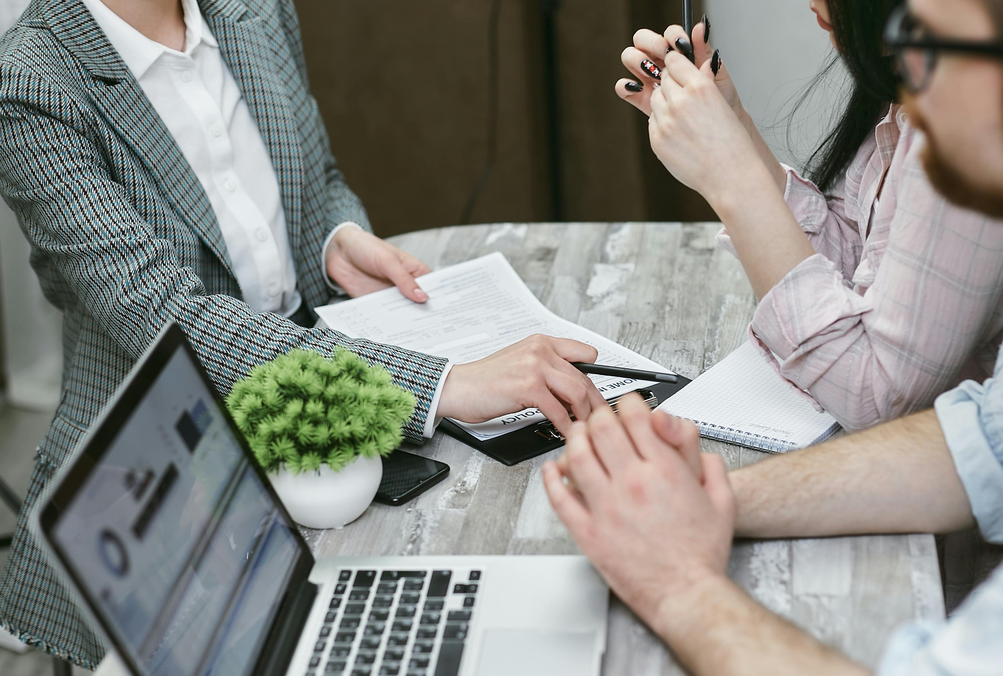 Financial analyst at desk with clients.